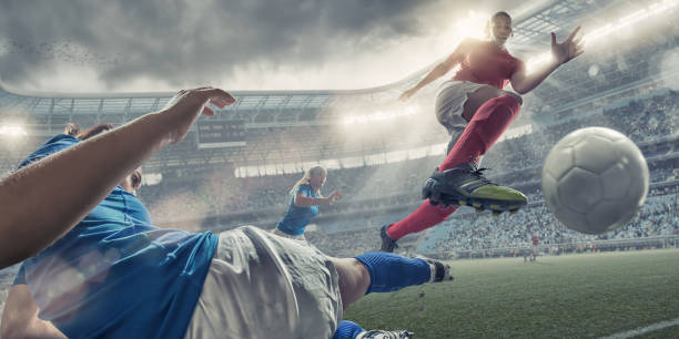 Women Soccer Players In Mid Air Action A cross processed mid action image of professional women soccer player in mid air jumping over a rival player who is performing a sliding tackle. The action takes place during a professional women’s football game in a generic floodlit soccer stadium full of spectators under a stormy evening sky at sunset. soccer striker stock pictures, royalty-free photos & images