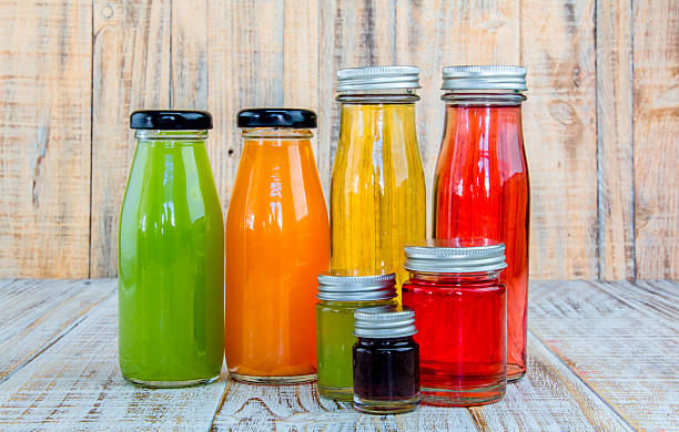 istock Juice bottle on wooden background 482570644