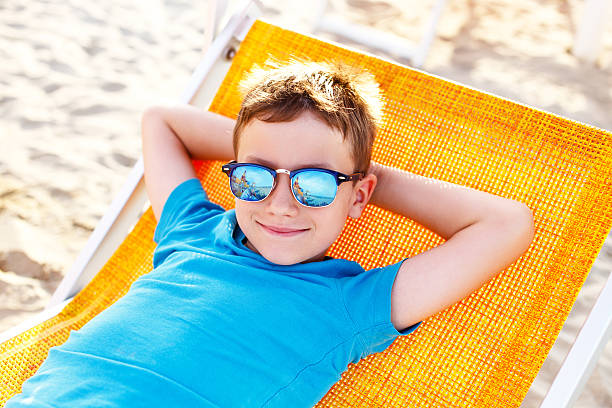 istock Little boy relax on deckchair 482570698