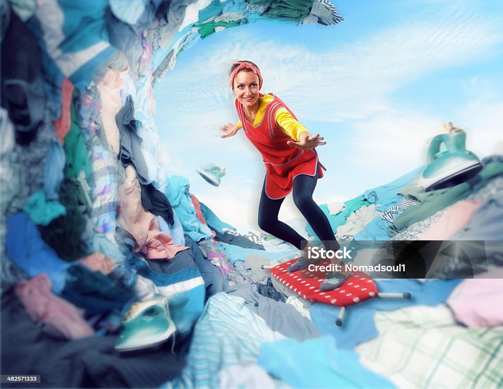 Happy smiling housewife surfing on ironing-board Happy smiling housewife surfing on ironing-board on clother Surfing Stock Photo