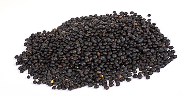 istock Heap of black lentil isolated on white 482572479