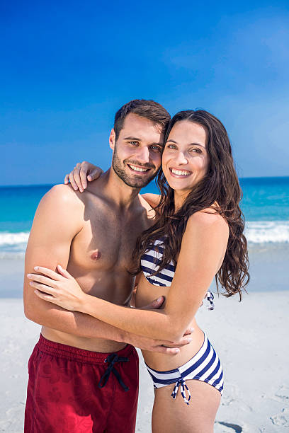 istock Happy couple embracing at the beach 482573276