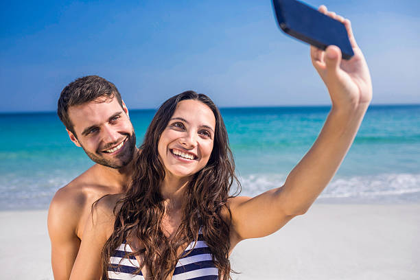 istock Happy couple taking a selfie at the beach 482574106