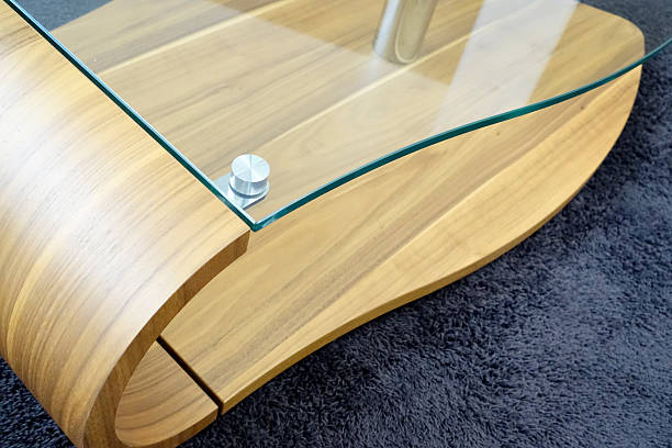 istock Modern glass wood table, standing on dark blue carpet 482577512