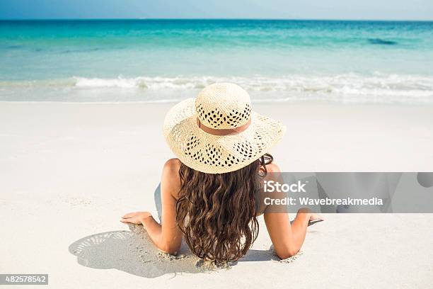 Rear View Of Pretty Brunette Looking At The Ocean Stock Photo - Download Image Now - Black Hair, Bright, Rear View