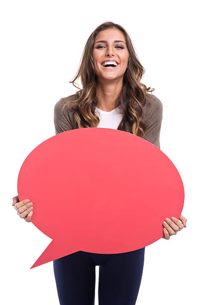 istock Young woman holding purple speech bubble 482581372
