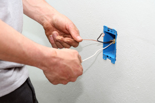 Electrician installing a new outlet.