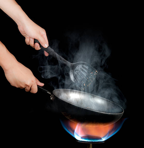 istock Chef cooking with flame in a frying pan 482582722