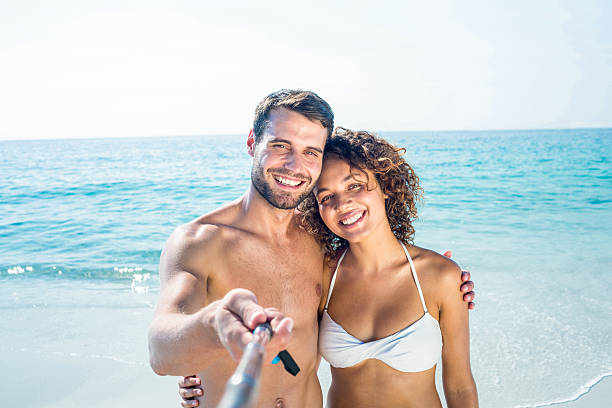 istock Happy couple doing selfie with monopod 482582988