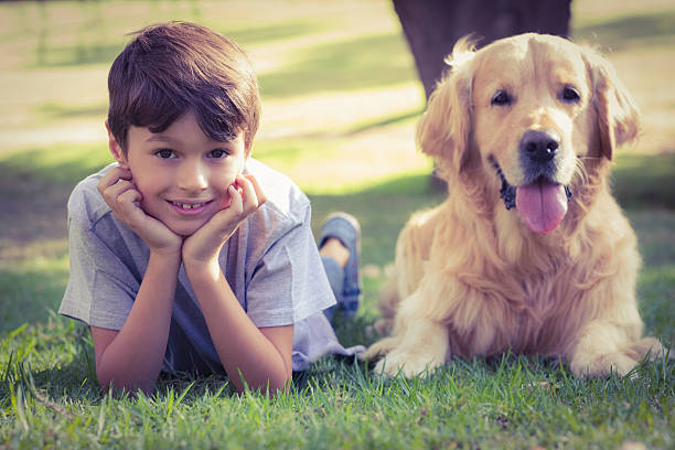istock Little boy looking at camera with his dog 482586494