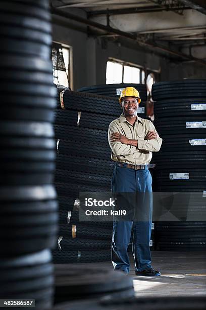 Man Working In Warehouse Stock Photo - Download Image Now - Tire - Vehicle Part, Manufacturing, Full Length