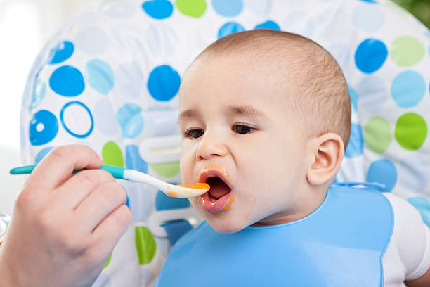 istock Adorable baby eating 482587110