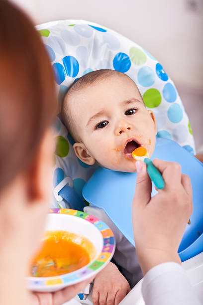 istock Cute little kid taking a bite of food 482587200