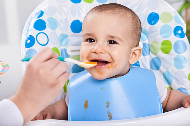 istock Smiling happy messy baby likes to eat 482587214