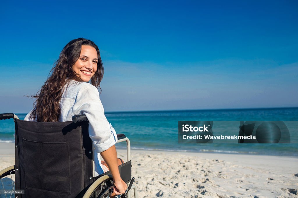 Disabled woman looking at camera Disabled woman looking at camera on a sunny day Wheelchair Stock Photo