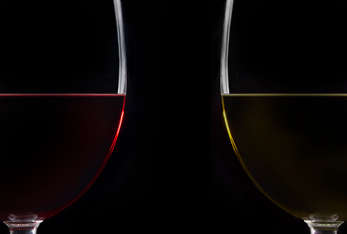 Red and white wine glass on black background