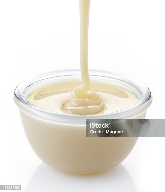 Pouring Condensed Milk With Sugar In A Bowl Stock Photo - Download Image Now - Bowl, Candy, Cooking