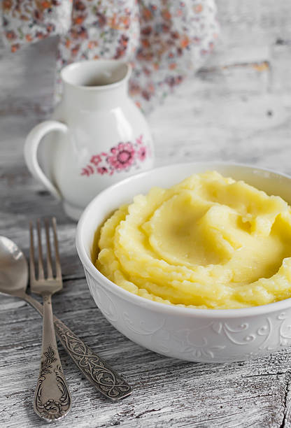 istock mashed potatoes in a white bowl on a light wooden background 482588320