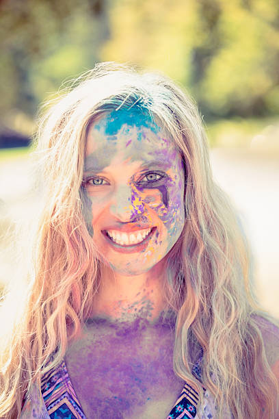 istock Young woman having fun with powder paint 482589410