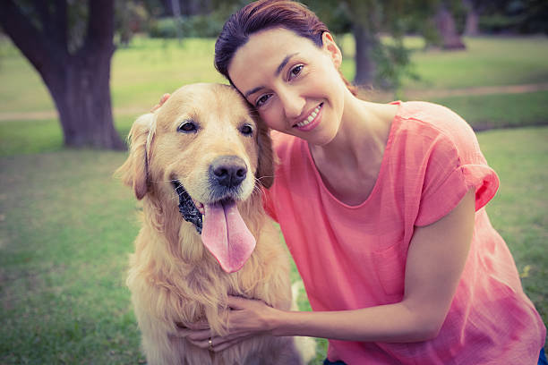 istock Pretty brunette looking at camera with her dog 482589814