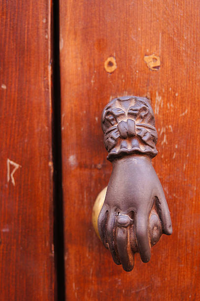 Old knocker in the shape of a hand on a door  in Marrakech, Morocco.