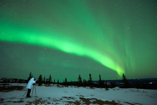 lone man photographing Aurora Borealis Northern Lights