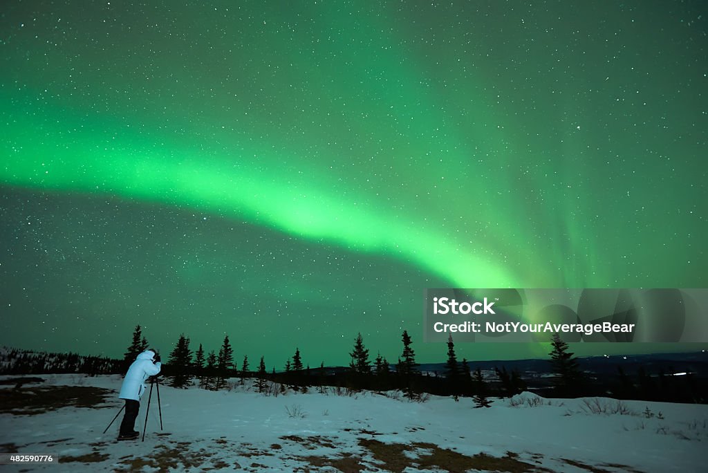 man photographing Aurora Borealis lone man photographing Aurora Borealis Northern Lights Alaska - US State Stock Photo