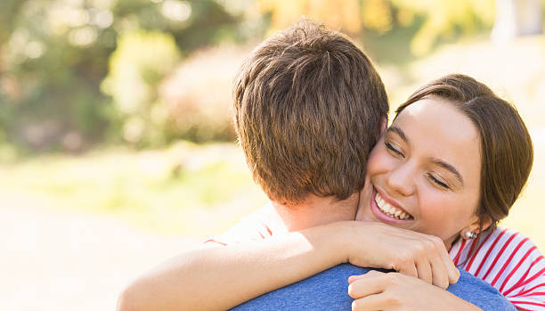 istock Cute couple hugging in the park 482596486