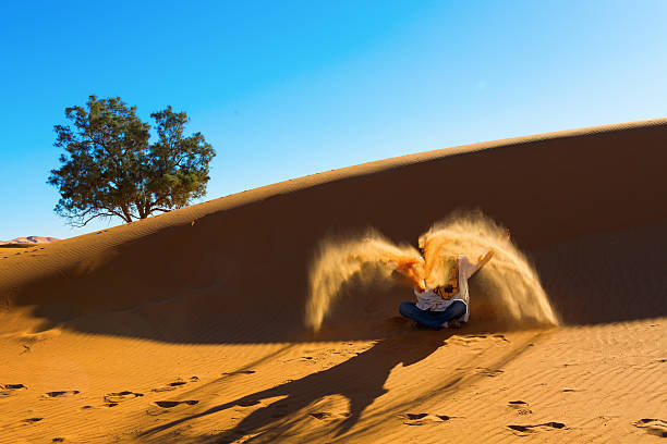 istock Berber playing and throwing with sands in Desert Sahara, creatin 482597317