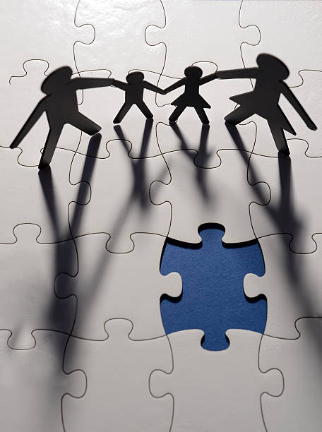 istock family figure on puzzle board 482597495