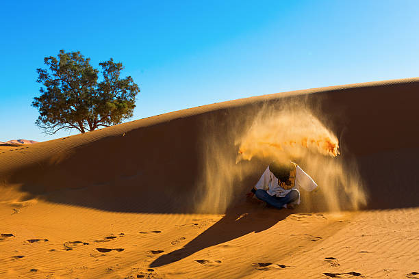 istock Berber playing and throwing with sands in Desert Sahara, creatin 482598077