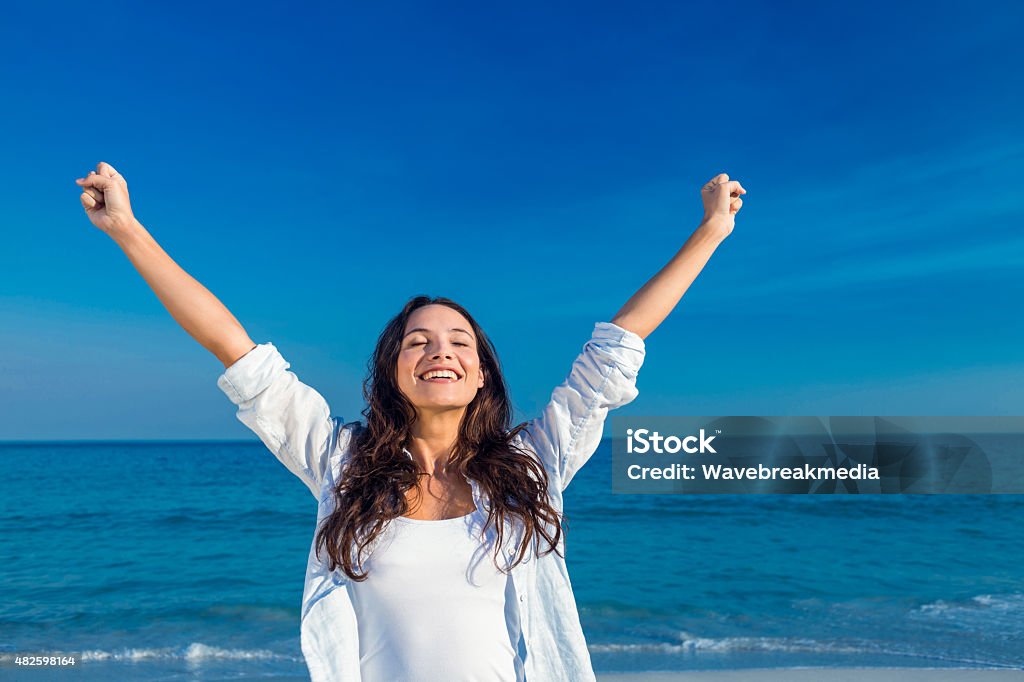 Happy woman smiling at the beach Happy woman smiling at the beach on a sunny day 20-24 Years Stock Photo