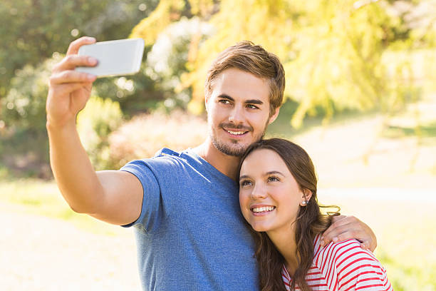 istock Cute couple doing selfie in the park 482598274