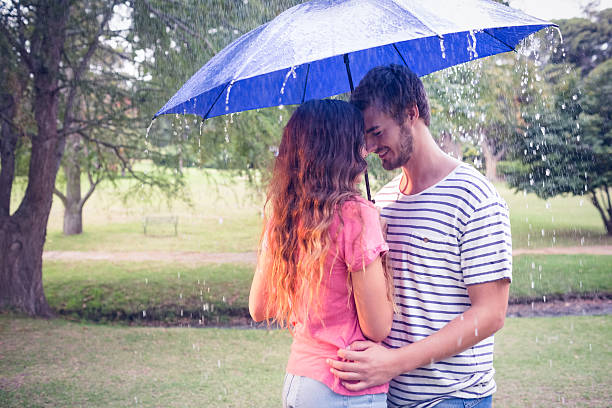 istock Cute couple hugging under the umbrella 482598350