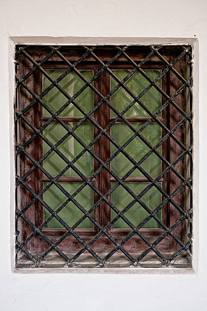 istock Close up Window with iron bar grill in stone wall 482599697