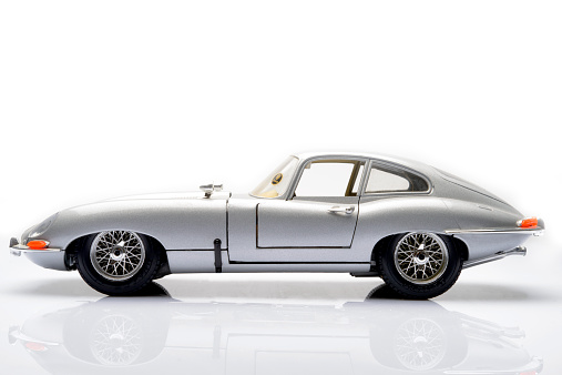 Kampen, The Netherlands - March 25, 2014: Jaguar E-Type classic sports car model by Bburago isolated on a white background.
