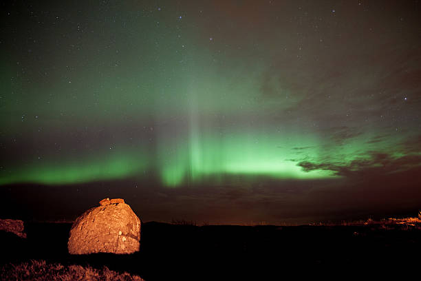 istock Northern lights with rock in foreground 482600853