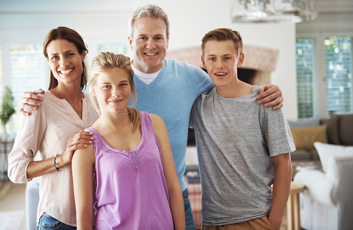 Portrait of a family of four standing together indoorshttp://195.154.178.81/DATA/istock_collage/0/shoots/784352.jpg