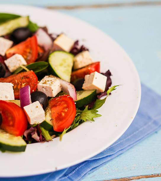 istock Greek salad on wooden background 482601253