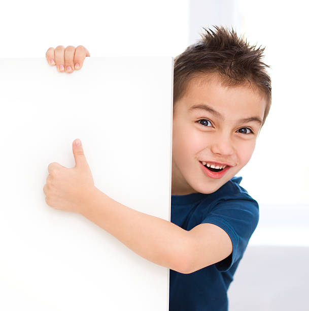 istock Cute boy is holding blank banner 482601813