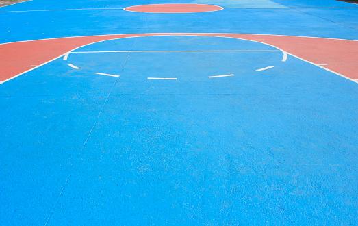 The basketball court with white lines.