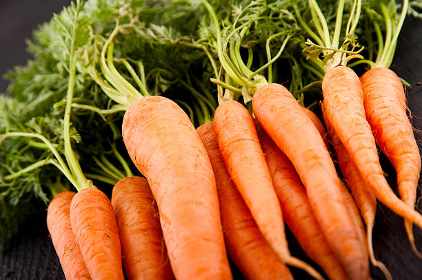 istock Fresh Organic Carrots on wooden background 482602537