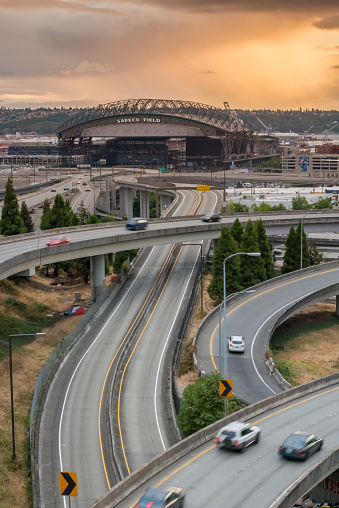 Seattle, USA - July 24, 2015: A vivid sunset late in the day over Safeco Field during a mariners home game with interstate 90 and Interstate 5 winding through the city. 