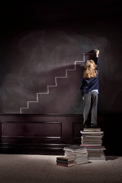 alta achiever - book child staircase steps foto e immagini stock