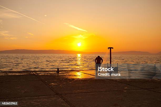 Taking A Shower On The Beach Stock Photo - Download Image Now - Beach, In Silhouette, One Man Only