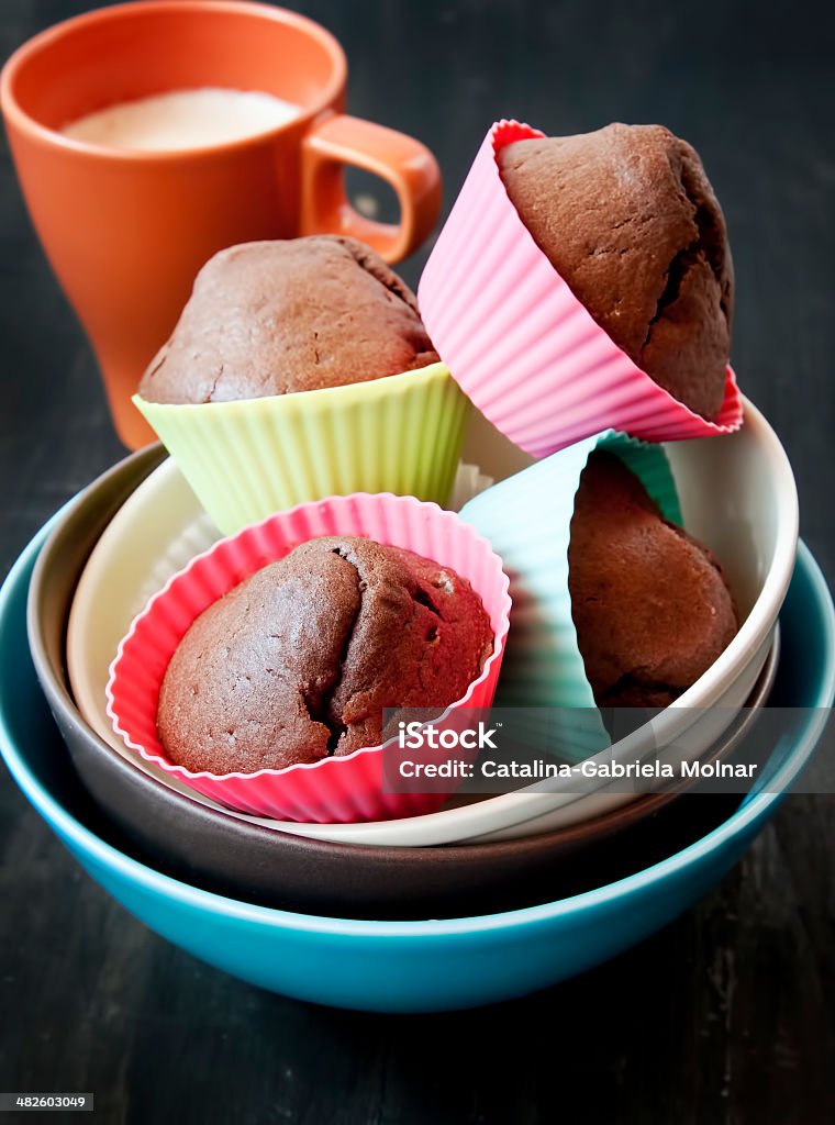 Chocolate Muffins and Cup of Milk Chocolate Muffins in Colorful Silicone Forms and Cup of Milk , Sweet Dessert Baked Stock Photo