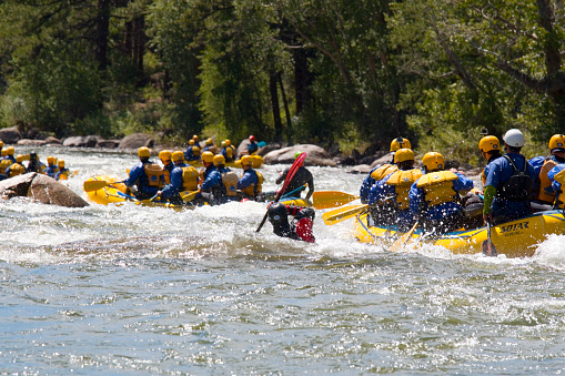 Buena Vista, Colorado, USA - July 11, 2015: People enjoying whitewater sports, including whitewater rafting and kayaking on the roiling whitewater of the Arkansas River near Highway 24 in Buena Vista Colorado