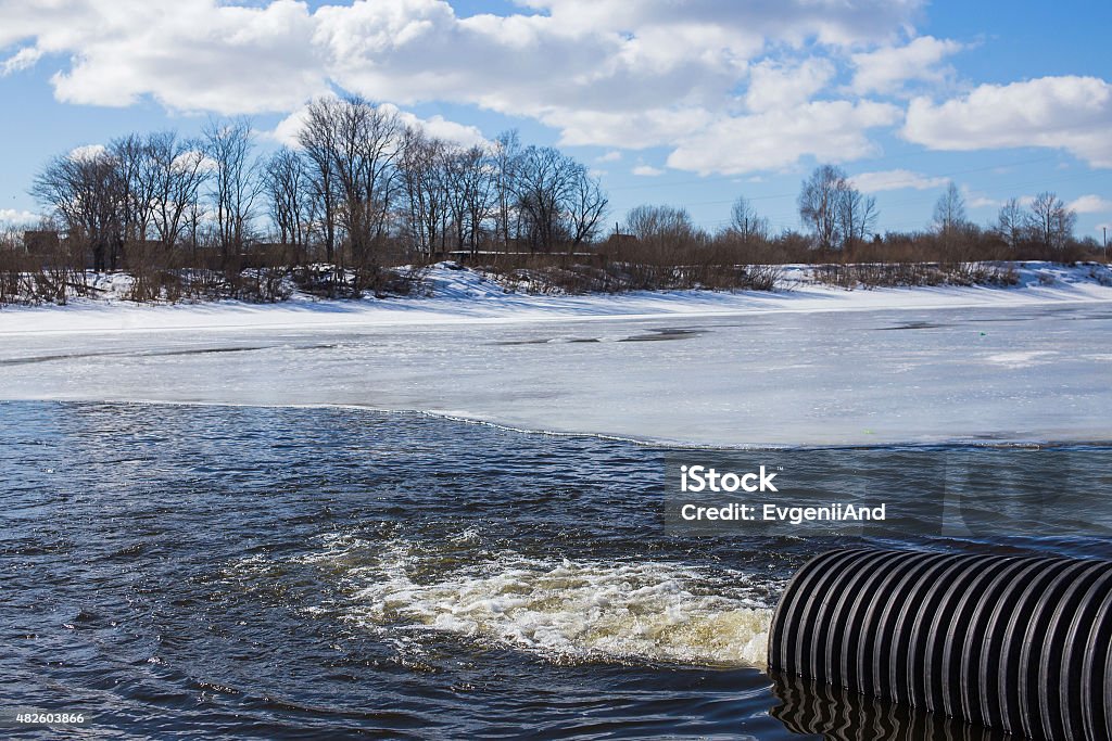 Dirty water discharged into river wastewater discharge through the pipe into the river Demobilization Stock Photo