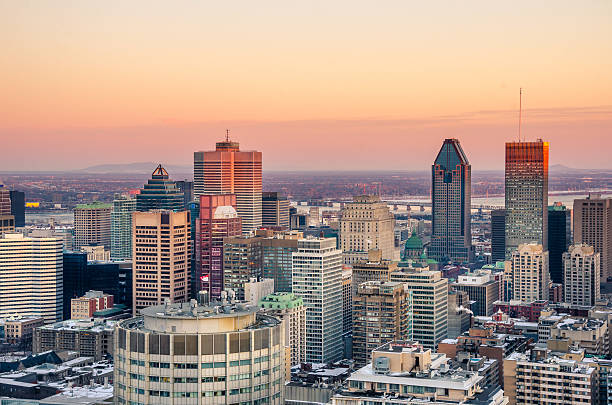 Sunset over Downtown Montreal in Winter Stunning Sunset over Downtown Montreal on a February cold day. The Saint Laurence river is visible in background under an orange sky. montreal stock pictures, royalty-free photos & images
