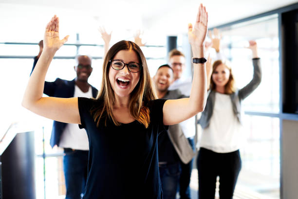 istock Female executive standing with arms up 482607082